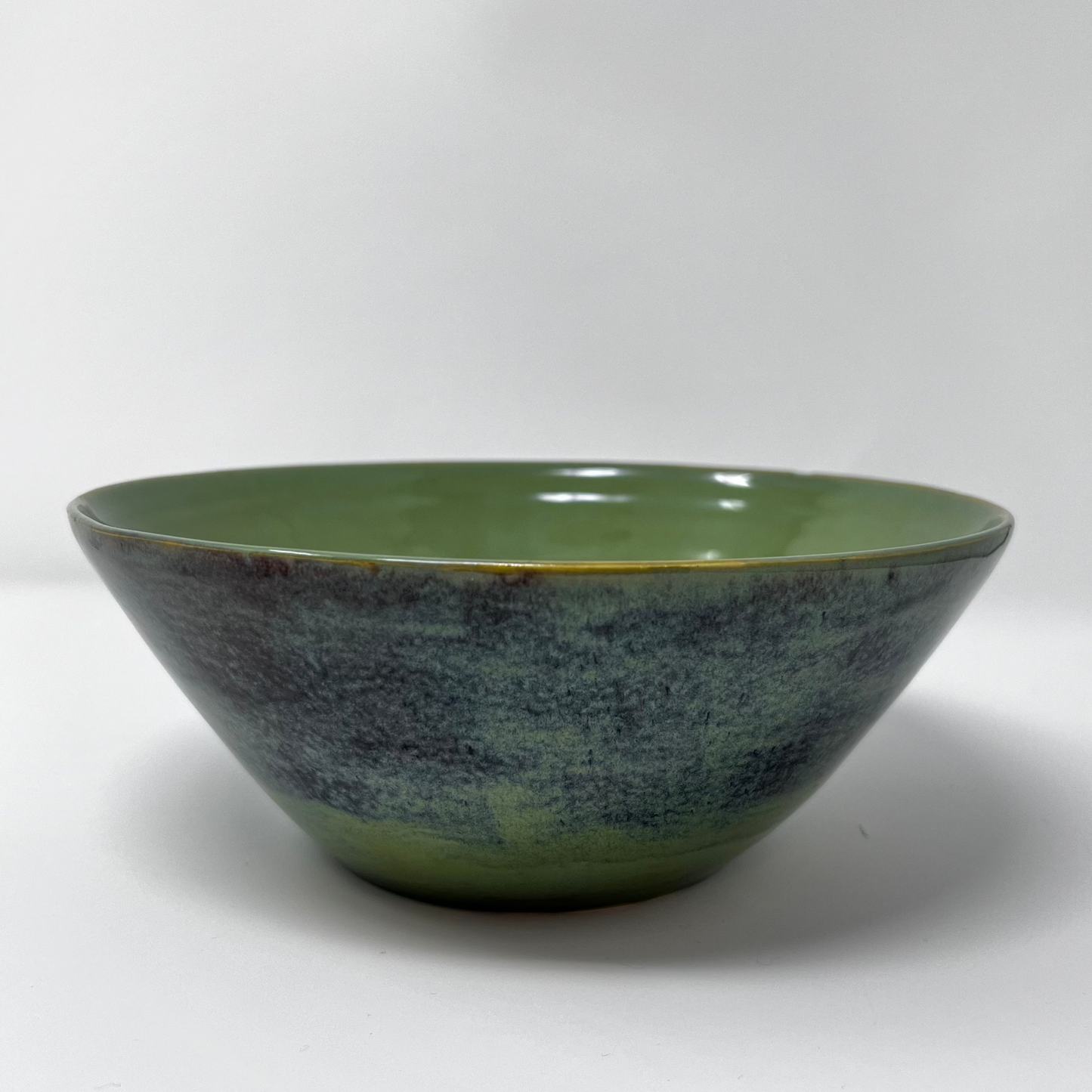 Handmade Pottery Bowl with Aqua Seaweed Glazing. A handcrafted ceramic bowl with a gradient glaze transitioning from earthy green to dark shades on the outside, and a glossy green finish on the inside.