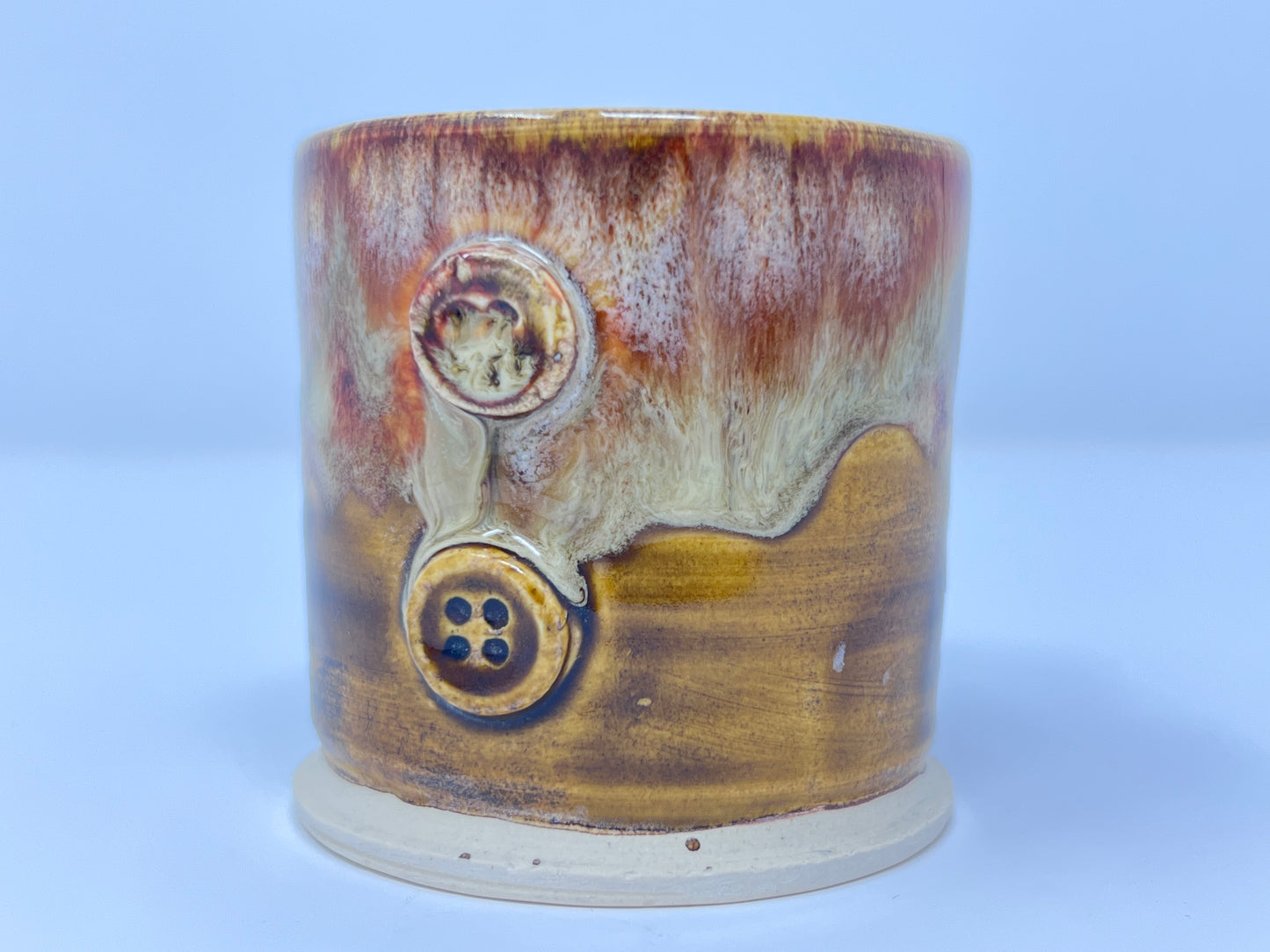 Handmade Ceramic Coffee Mug - Earthy Drip Glaze with Sculpted Handle and Button Accent - Front view of buttons